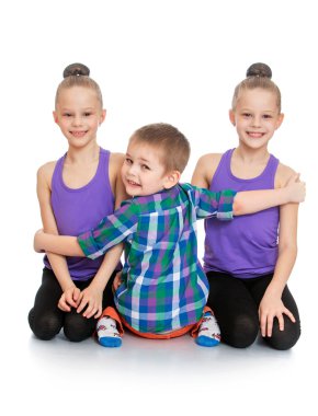 Brother hugs his sisters