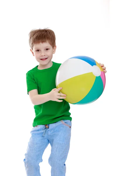 Little boy with a striped ball — Stock Photo, Image