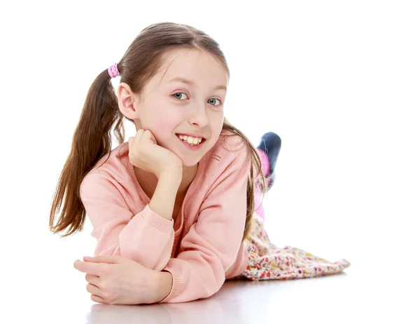 Little long-haired girl lying on the floor — Stok fotoğraf