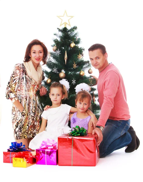 Happy family at the Christmas tree — Stock Photo, Image