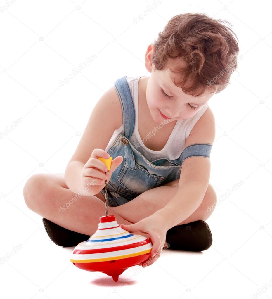 Boy playing with a spinning top