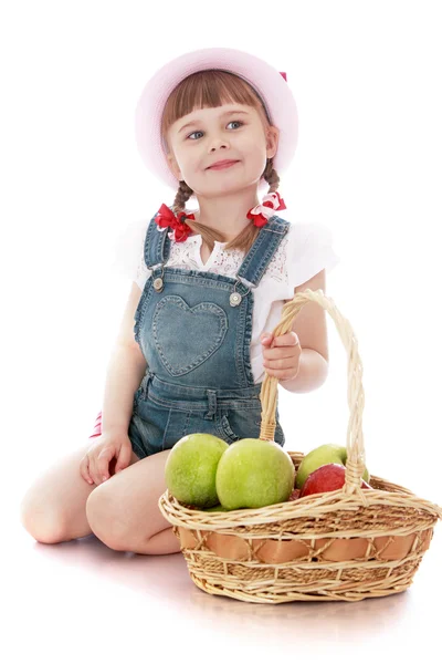 Little girl with a basket of apples — Stock Photo, Image