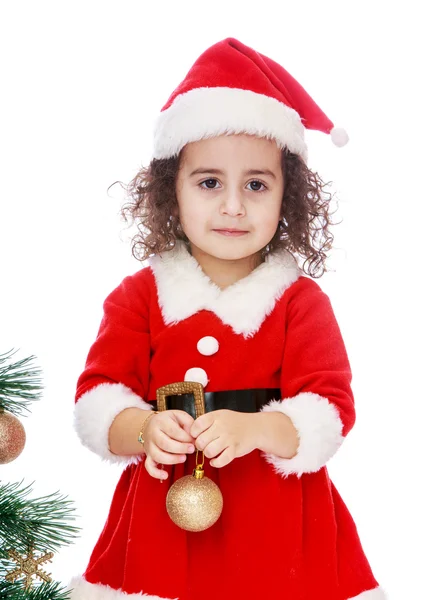 Girl dressed as Santa Claus with a toy in the hands of — Zdjęcie stockowe