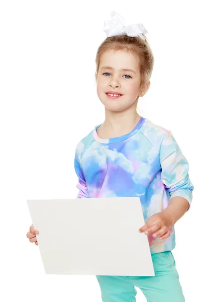 Girl holds up a sheet of paper — Stok fotoğraf