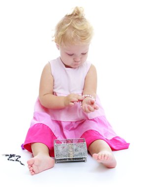 Little girl trying on jewelry