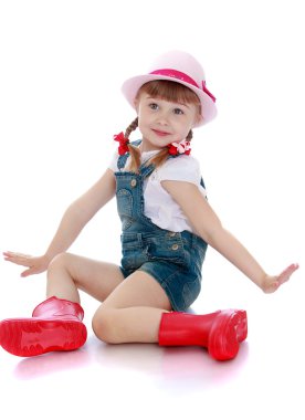 Little girl in red boots