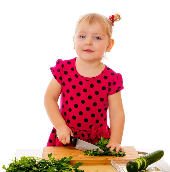 Little girl cut vegetables — ストック写真