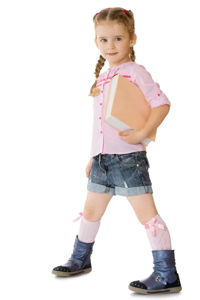 Girl with a book under her arm — Stock Photo, Image