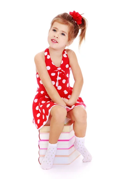 Girl sitting on books — Stock Photo, Image