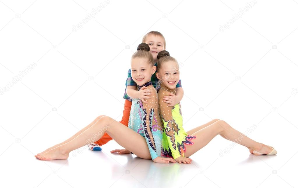 Boy hugging girls gymnasts