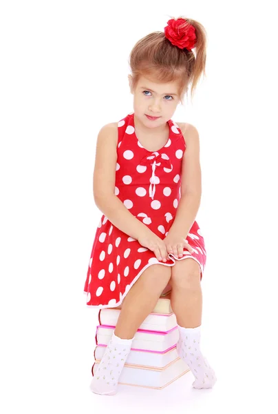 Girl sitting on books — Stock Photo, Image