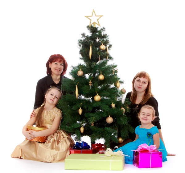 Family at the Christmas tree — Stock Photo, Image