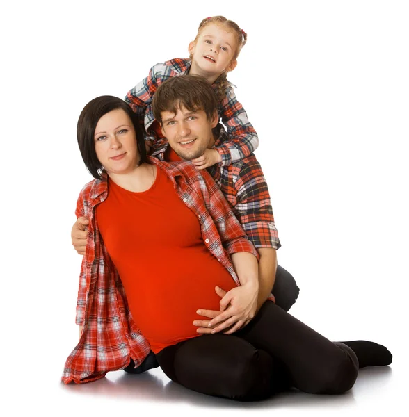 Família abraçando mãe grávida — Fotografia de Stock