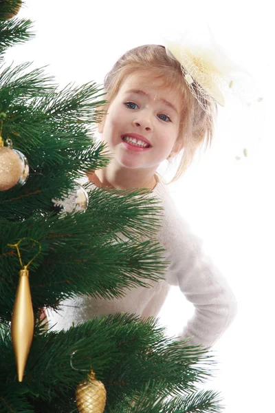 Pretty girl in a Christmas tree — Stock Photo, Image