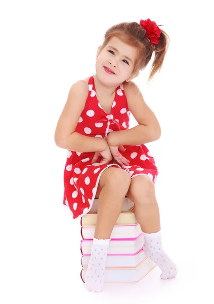 Girl sitting on books — Stock Photo, Image