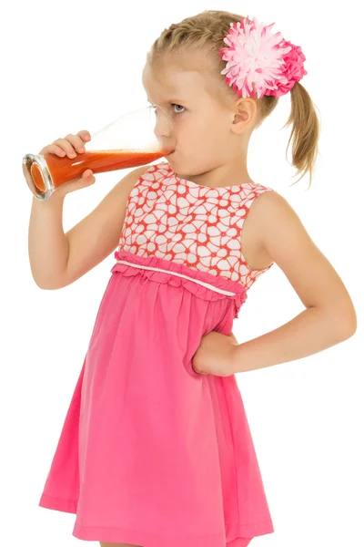Girl drinks juice from a glass — Stok fotoğraf