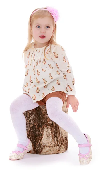 Little girl sat down on a stump — Stock Photo, Image