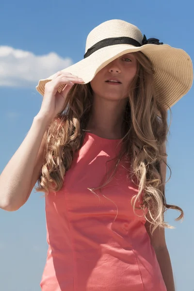 Young attractive woman holding her hat — Stock Photo, Image