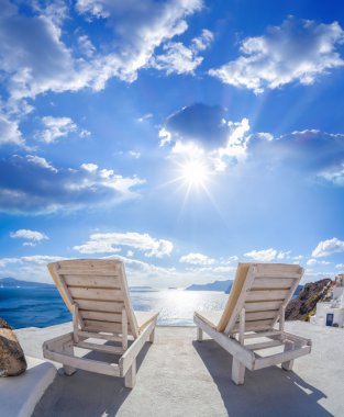Oia village with sunbeds on Santorini island in Greece clipart