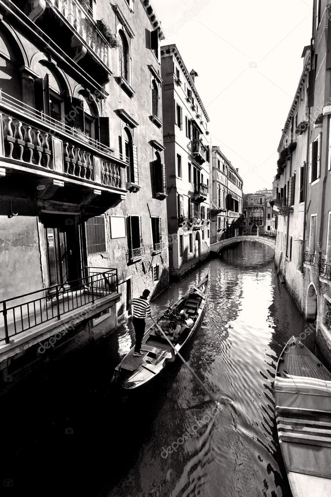 Venice with gondolas on canal in Italy