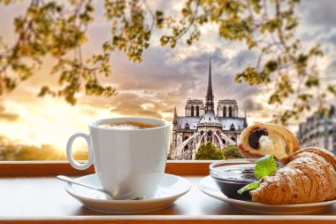 Notre Dame cathedral with coffee and croissants in Paris, France clipart