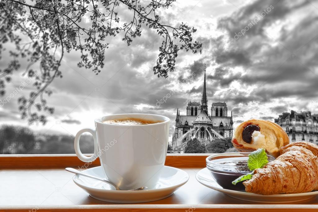 Notre Dame cathedral with coffee and croissants in Paris, France