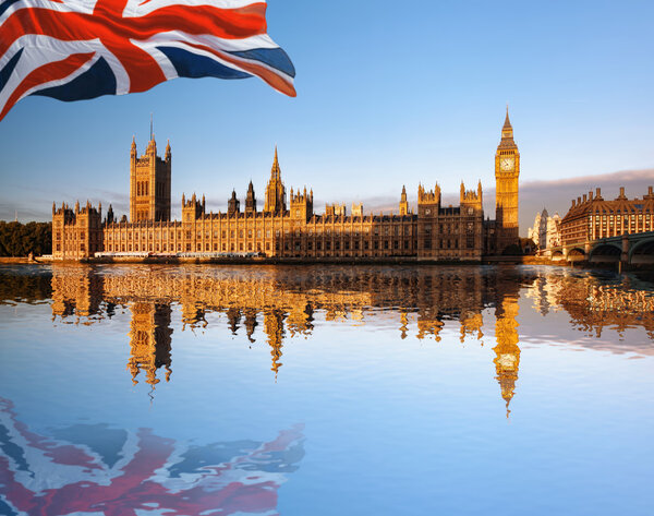 Big Ben with flag of England in London, UK