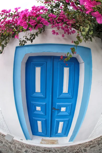 Porta tradizionale greca con fiori nel villaggio di Oia sull'isola di Santorini, Grecia — Foto Stock