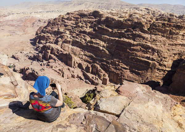 Women takes photo on High Place of Sacrifice. Petra. Jordan. 