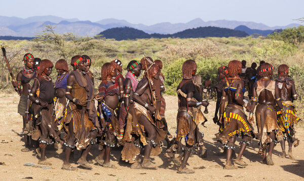 Group of Hamar women dance during bull jumping ceremony.