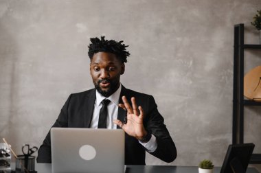 Kendine güvenen Afrikalı genç adam web kameralı konferans videosuna bak ofisi arıyor, mutlu karışık ırk girişimcisi konuşuyor çevrimiçi görüntülü sohbet işi görüşmesi yapıyor.