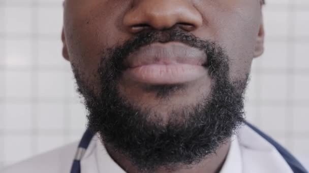 Close-up portrait of black doctor smiling and looking at camera — Stock Video
