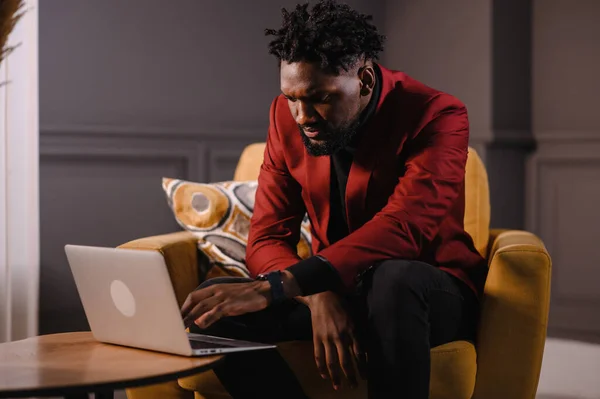 Male african american user hands typing on laptop keyboard sit at table, mixed race ethnic student professional study work with pc software technology concept, close up view