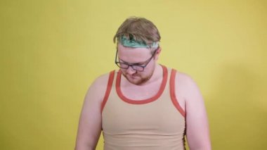 komik şişman adam dambıllarla egzersiz yapıyor. Fazla kilolu. sarı arkaplan