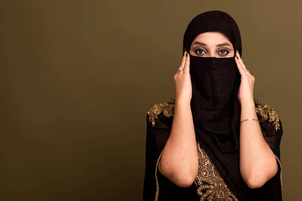 Muslim woman in hijab. Portrait of a young arab girl in traditional dress. White background.
