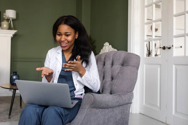 portrait of afro american female doctor using laptop computer. online consultation