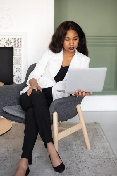 Female Entrepreneur. Cheerful African American Businesswoman Working On Laptop In Modern Office.