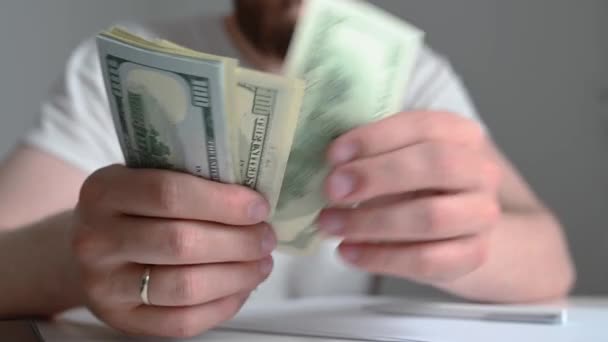 Male hands counting US Dollar bills or paying in cash on money background. Concept of investment, success, financial prospects — Stock Video