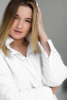 attractive fat woman in a white oversized shirt. Beautiful smiling woman