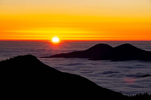 Sea of clouds in the valley with sun rising