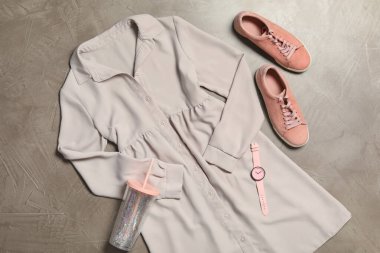 Gri taştan arka planda şık bir elbiseyle düz konum