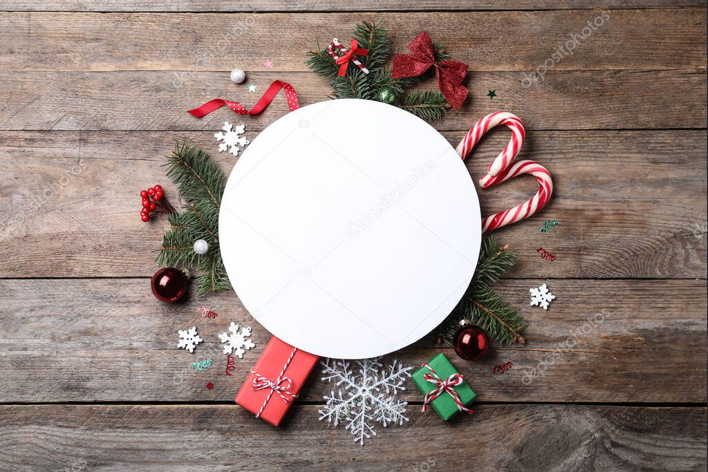 Flat lay composition with Christmas decor and blank card on wooden table. Space for text