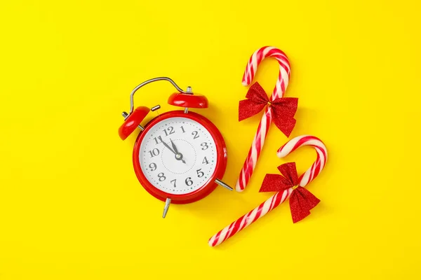 Alarm Clock Candy Canes Yellow Background Flat Lay New Year — Stock Photo, Image