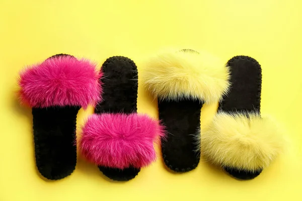 Different soft slippers on yellow background, flat lay