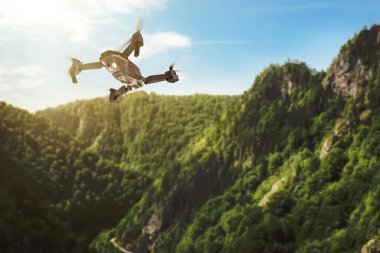 Modern insansız hava aracı resimli dağların üzerinde uçuyor. Hava İncelemesi