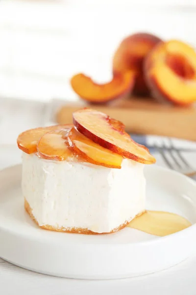 Delicious dessert with peach slices on plate