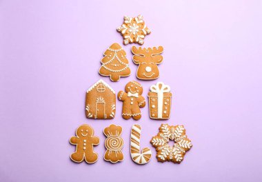 Lezzetli zencefilli kurabiyelerden yapılmış Noel ağacı şekilli leylak arka planda, düz uzanmış