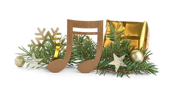 モミの木の枝と白い背景にクリスマスの装飾と木製の音楽ノート — ストック写真