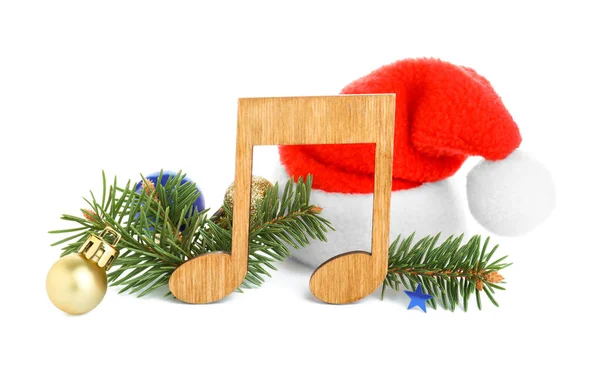 带有圣诞礼帽 枞树枝条和白色背景圣诞装饰的木制乐谱 — 图库照片