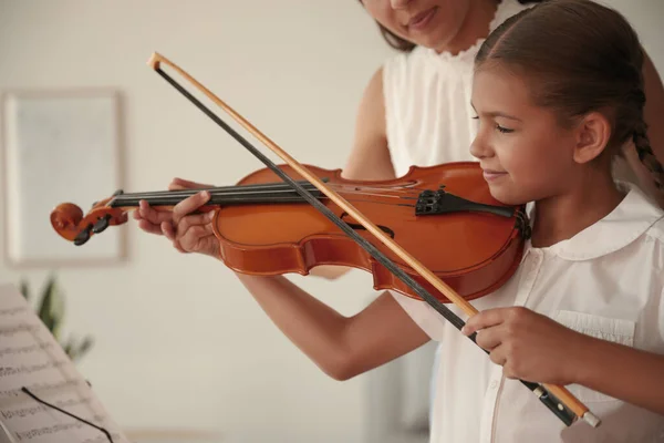 教小女孩在室内拉小提琴的年轻女子 — 图库照片